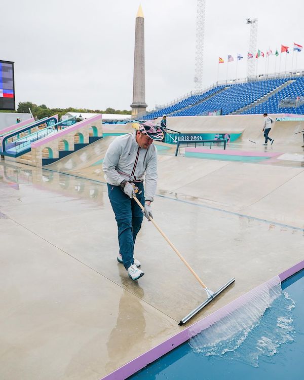 man squeegees the olympic street skatepark